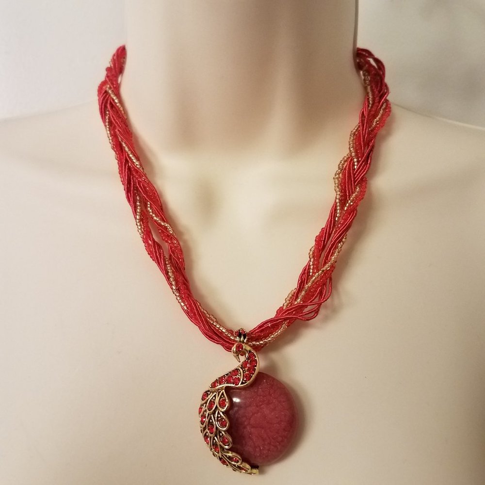 Red beaded necklace with rhinestone peacock charm